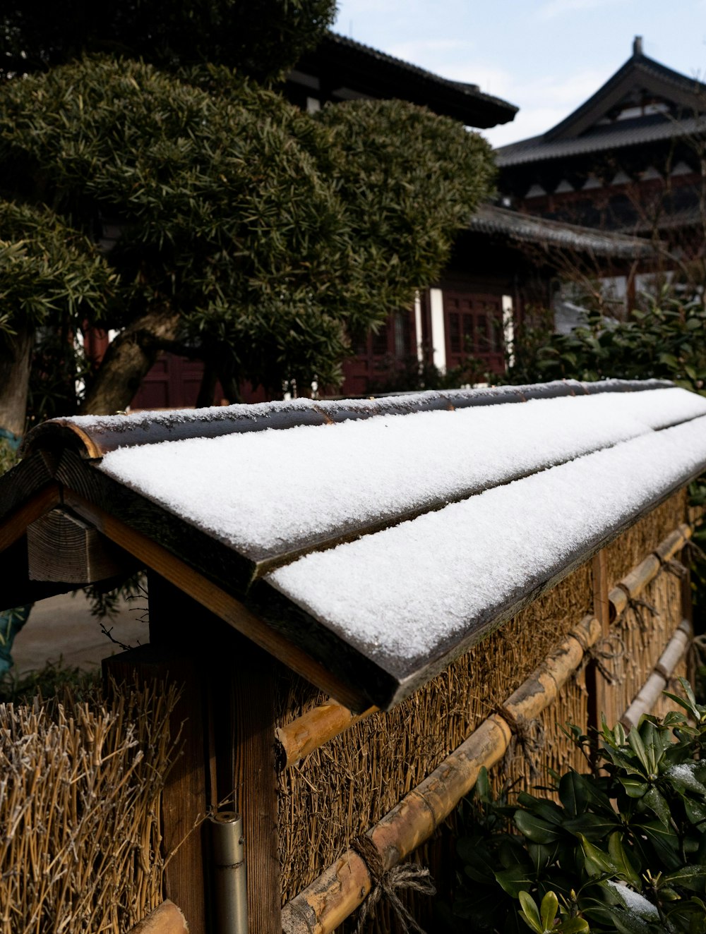 a snow covered roof in front of a building