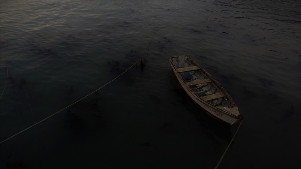 a small boat floating on top of a body of water