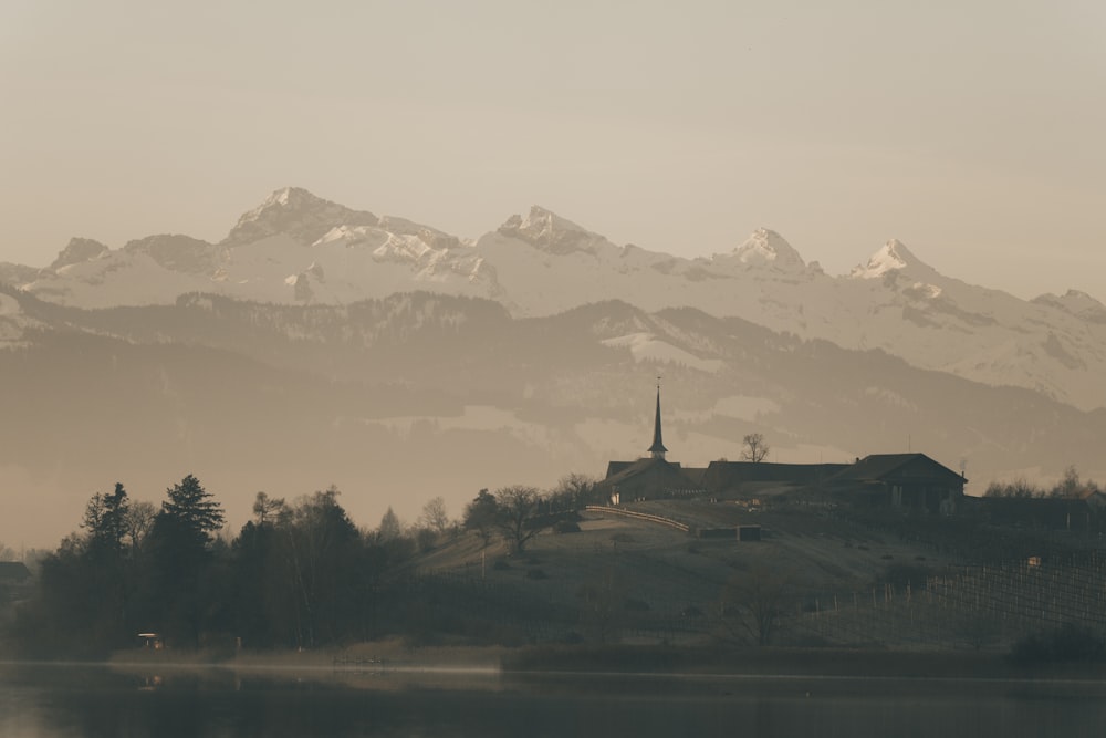 a church on a hill with a lake in front of it