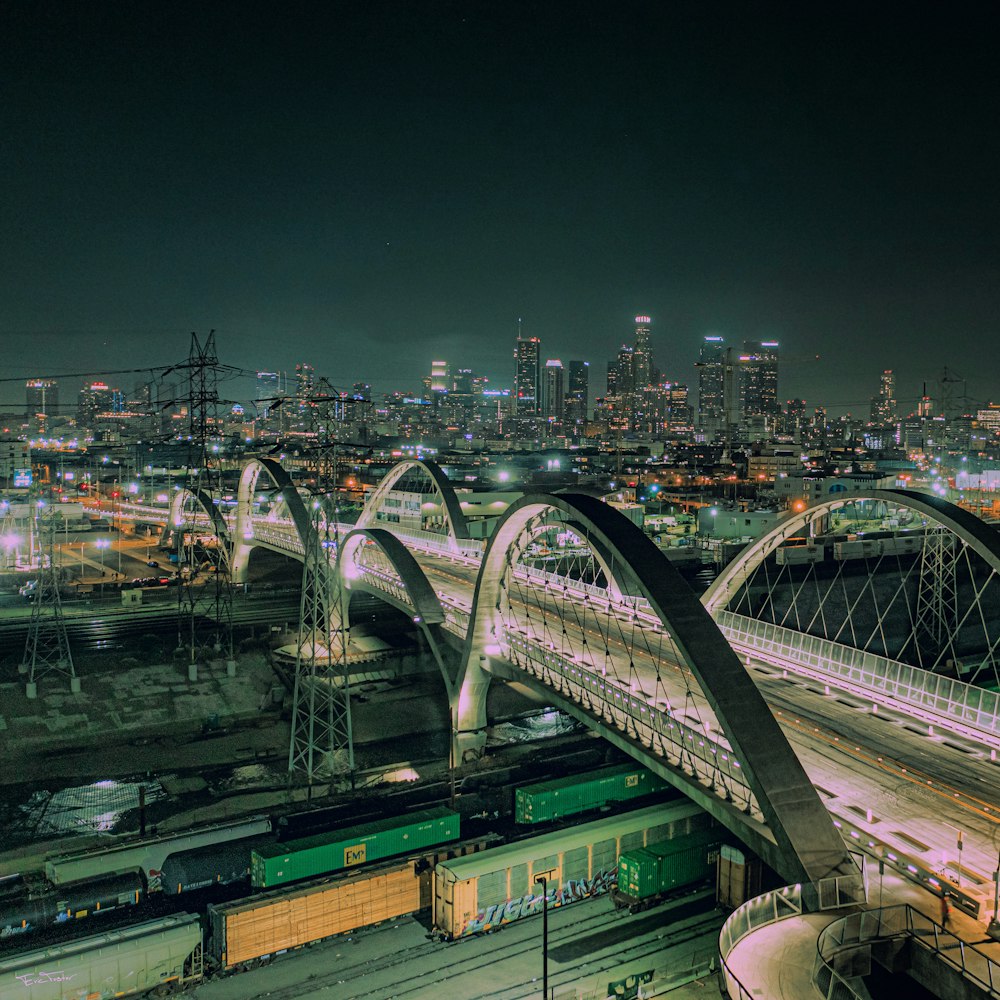 a train traveling over a bridge at night