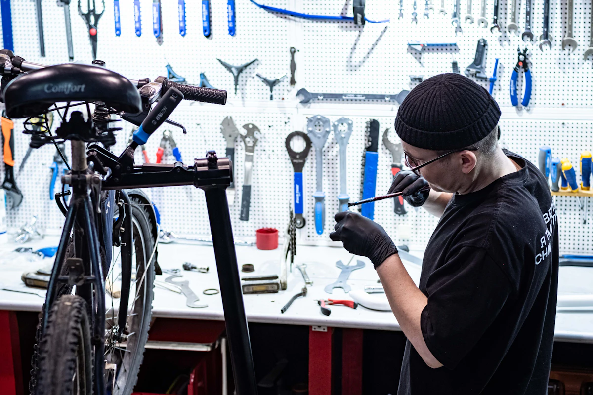A mechanic torquing a stem bolt with the bike up in the stand.
