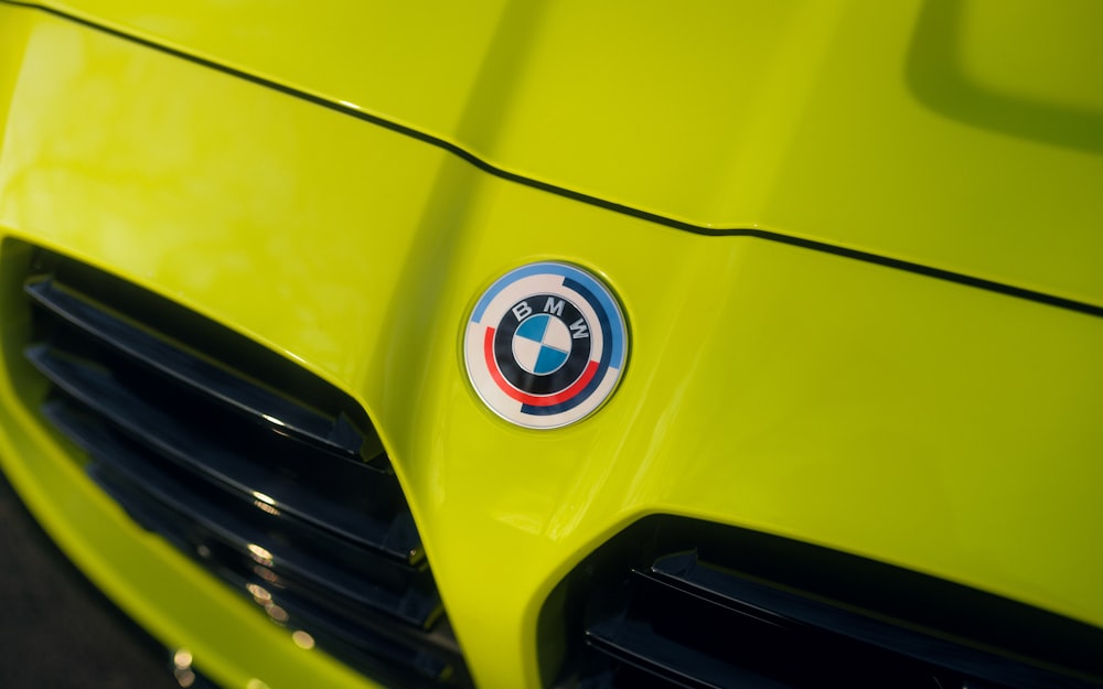 a close up of the front of a yellow sports car