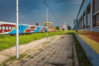 a train on a train track next to a grassy field