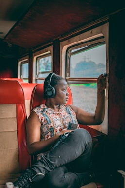 a woman sitting on a train looking out the window