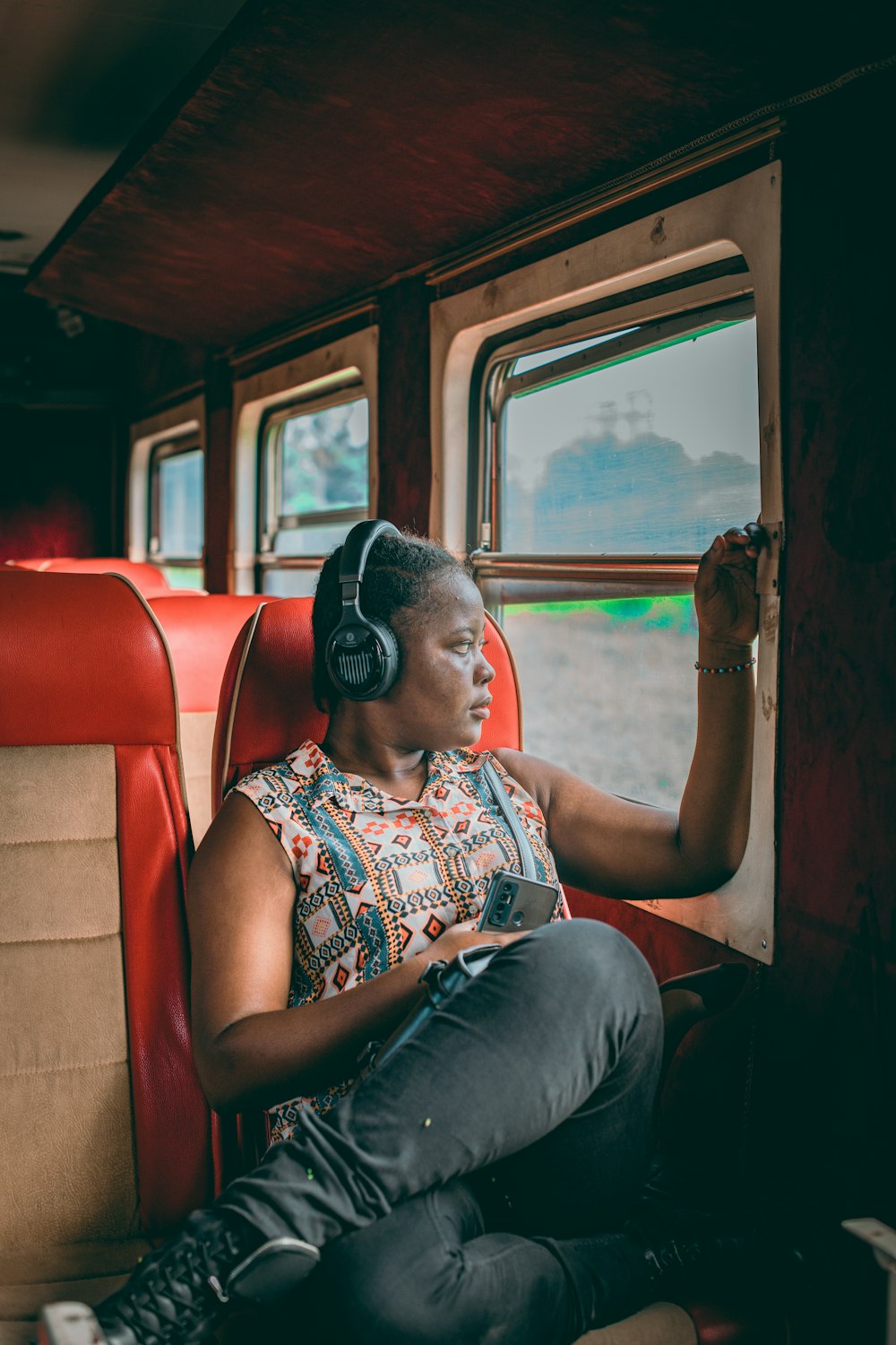 a woman sitting on a train looking out the window