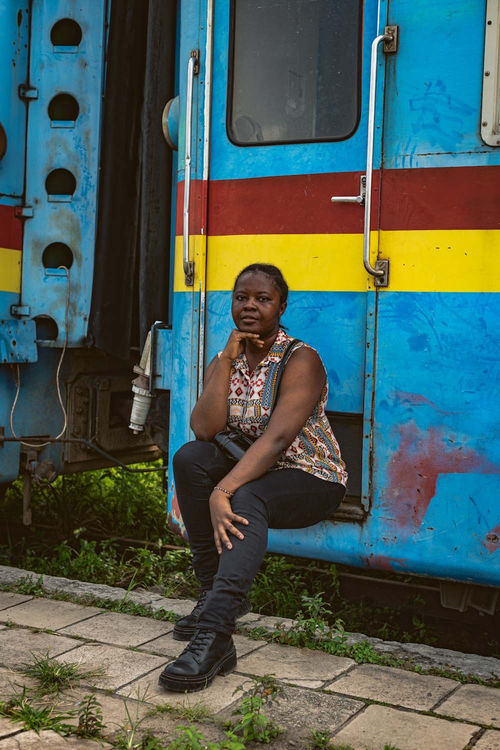 a woman sitting on the side of a train