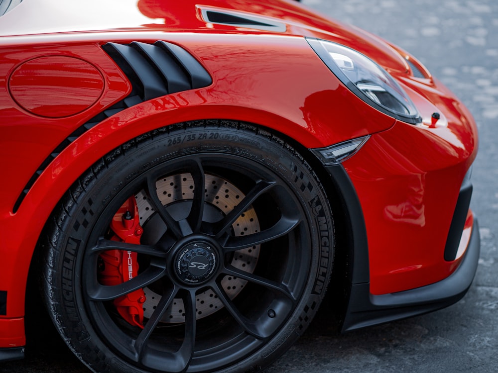 a close up of the front of a red sports car