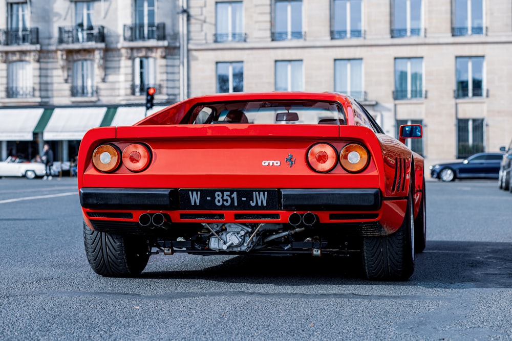 a red sports car parked on the side of the road