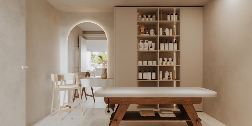A serene wellness clinic interior with sage and neutral tones accented by tangerine.