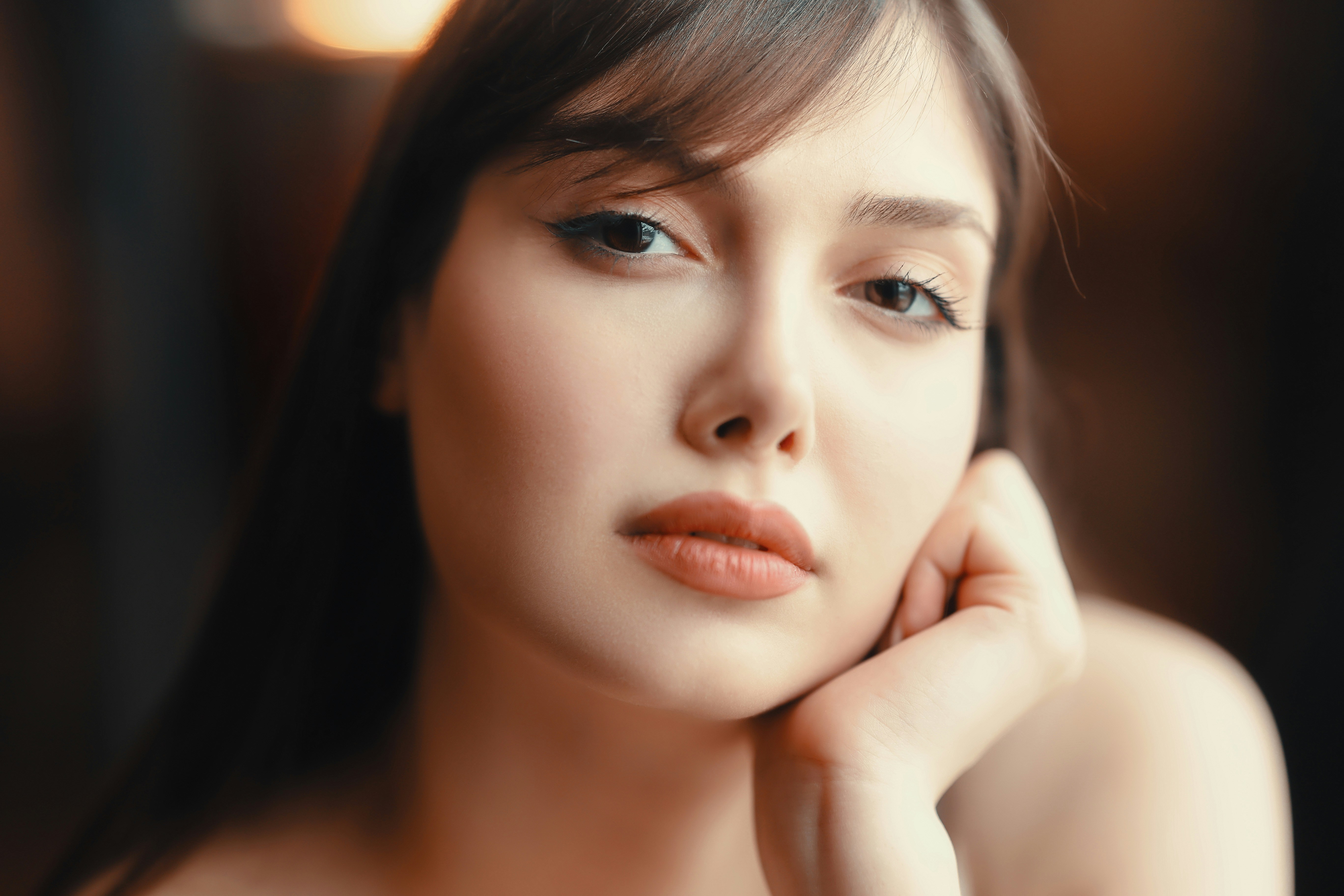 a woman is posing for a picture with her hand on her chin