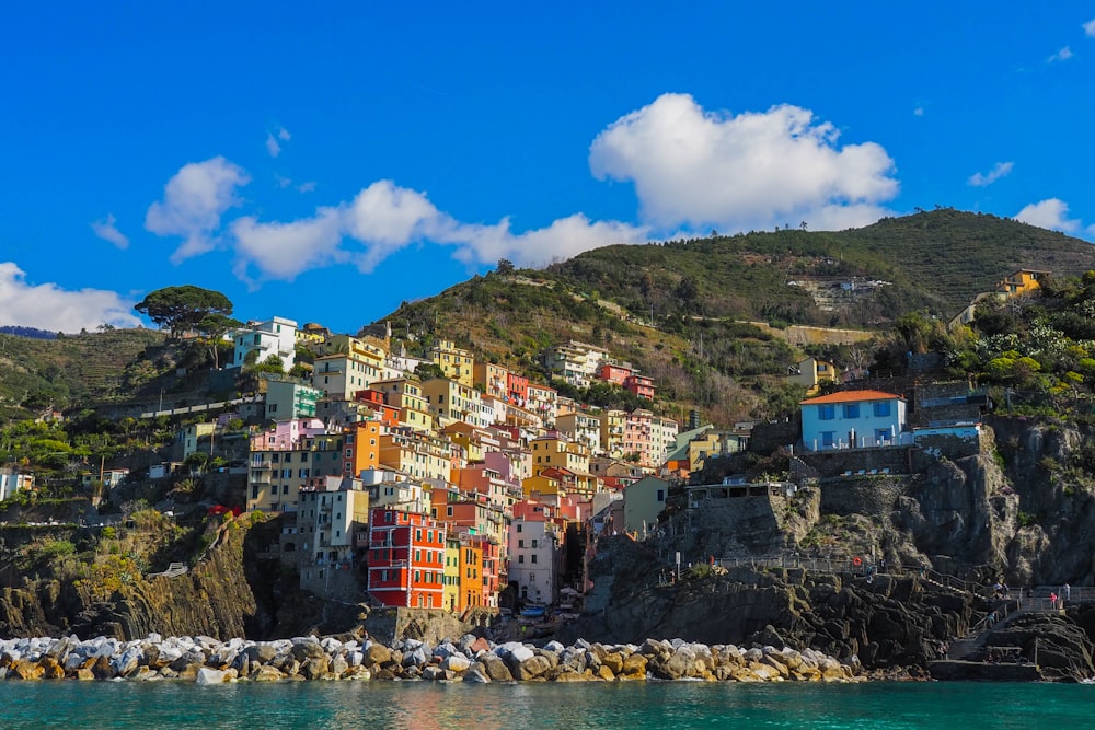 a small village on the side of a cliff next to the ocean