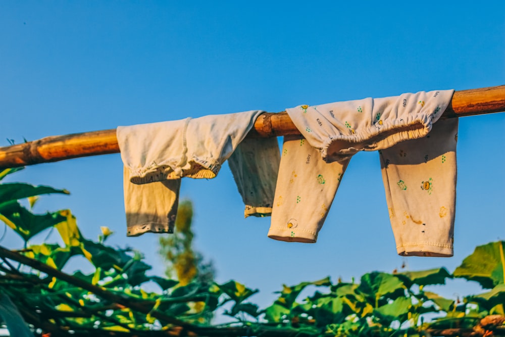 clothes hanging on a clothes line in front of a blue sky