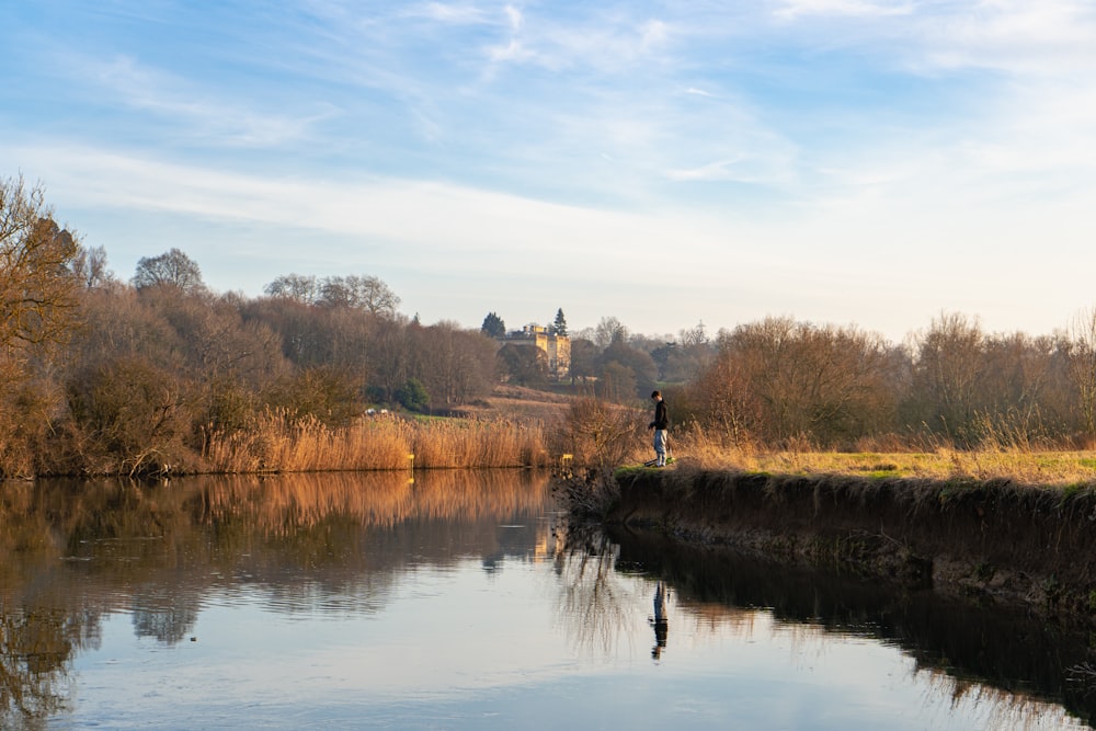 a person standing on the edge of a body of water