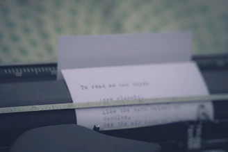 A close-up of a vintage typewriter with a half-typed confidential document on textured paper.