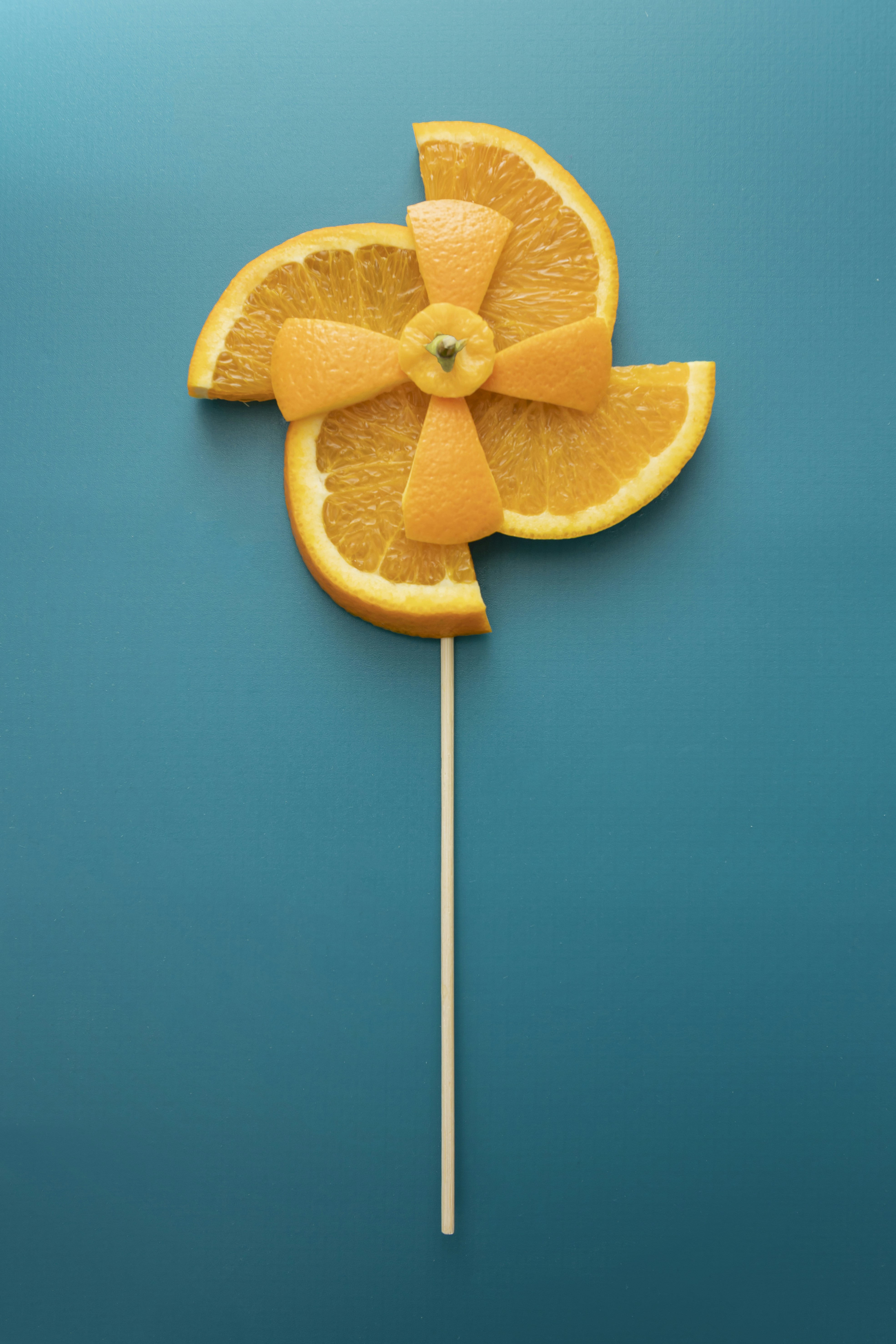 a close up of an orange on a stick
