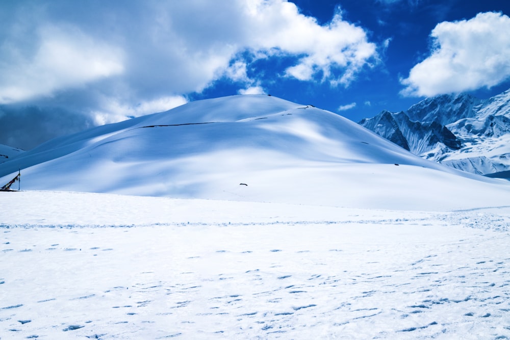 a snow covered mountain with tracks in the snow