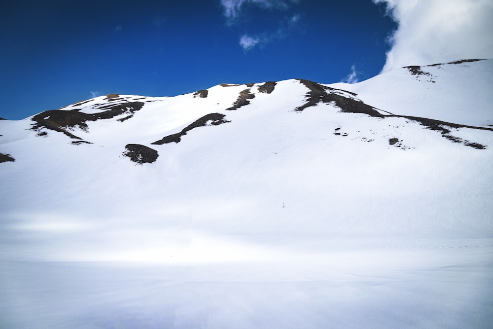 a man riding skis down a snow covered slope