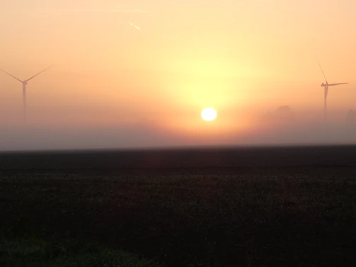 Sunrise over a quiet refinery, symbolizing the start of a new day in sustainable energy production.
