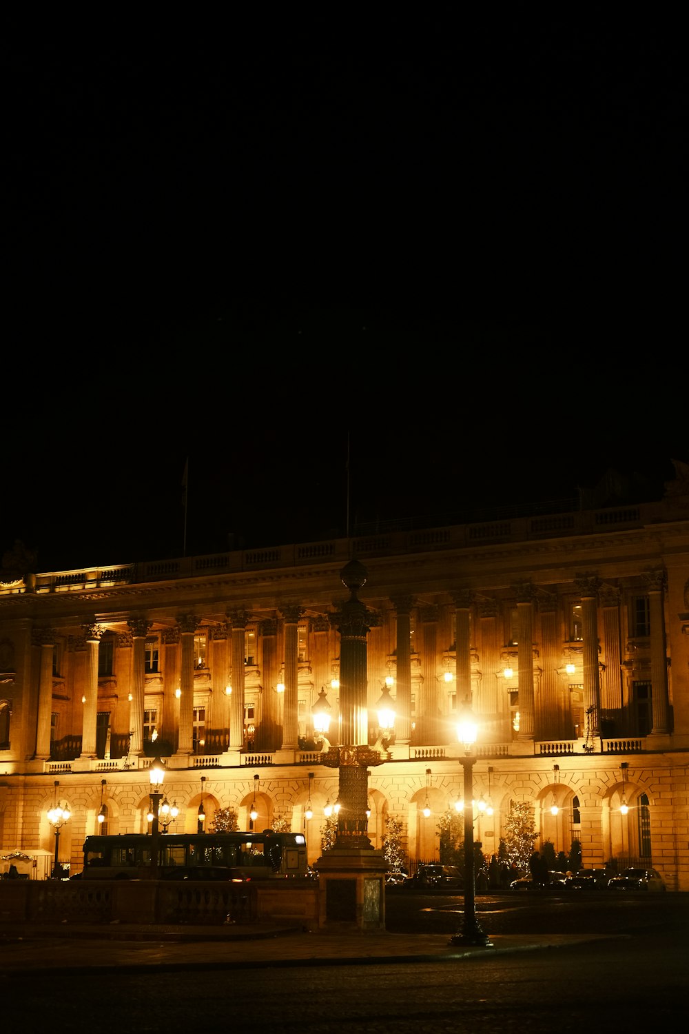 a large building lit up at night with street lights