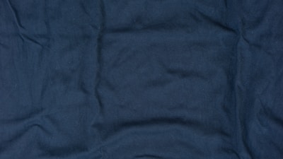 Plain sinker knit fabric draped gently to reveal its even and dense weave.