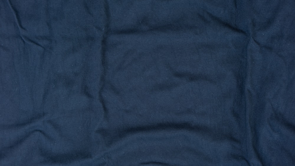 a close up of a blue cloth with a white background