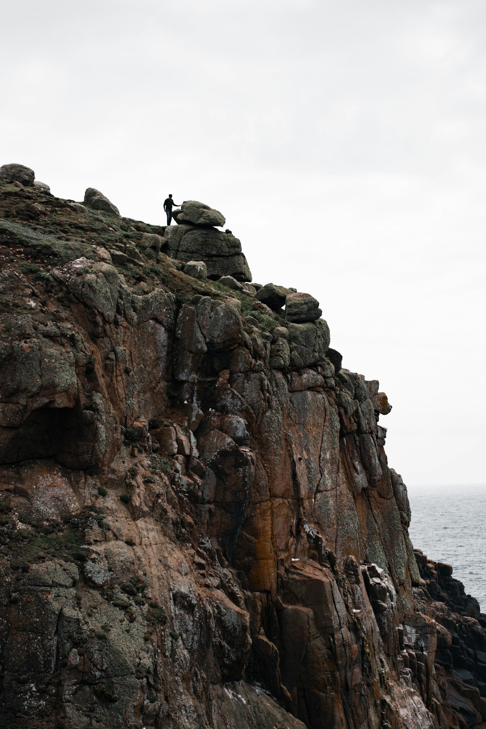 a person standing on top of a rocky cliff