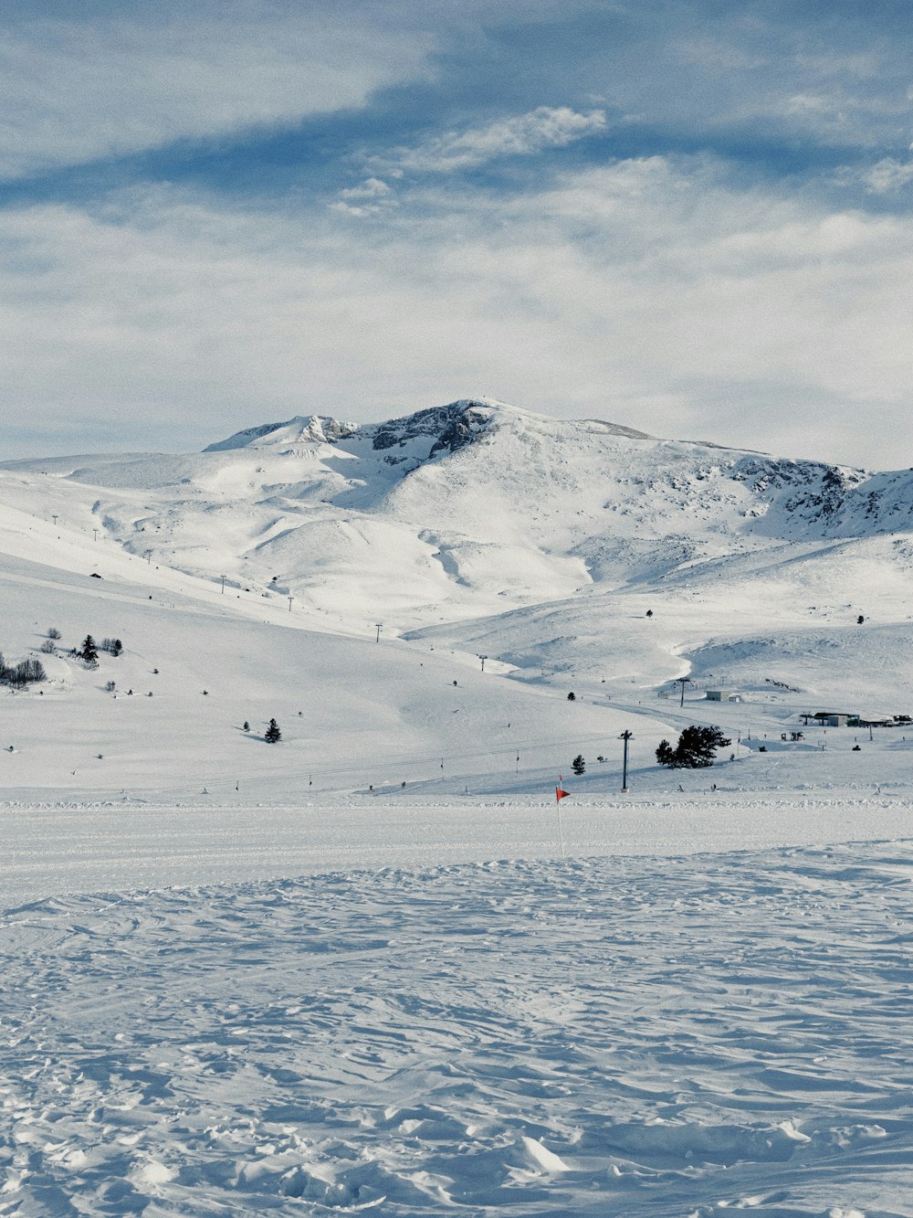 a person on skis in the snow with mountains in the background