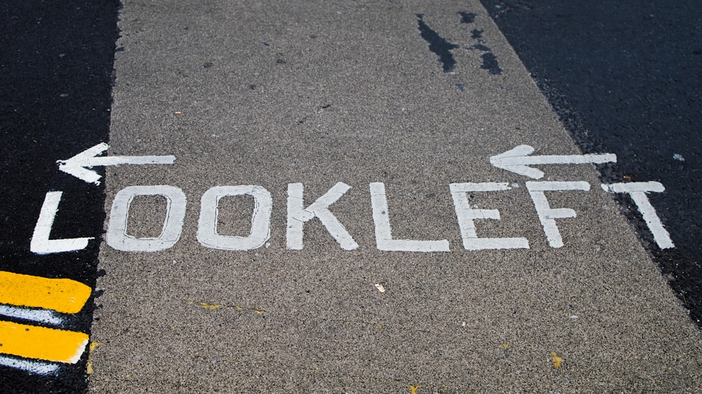 a street sign that says look left on the ground