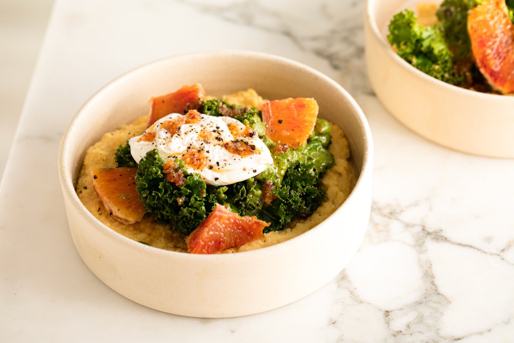 two bowls of food on a marble table