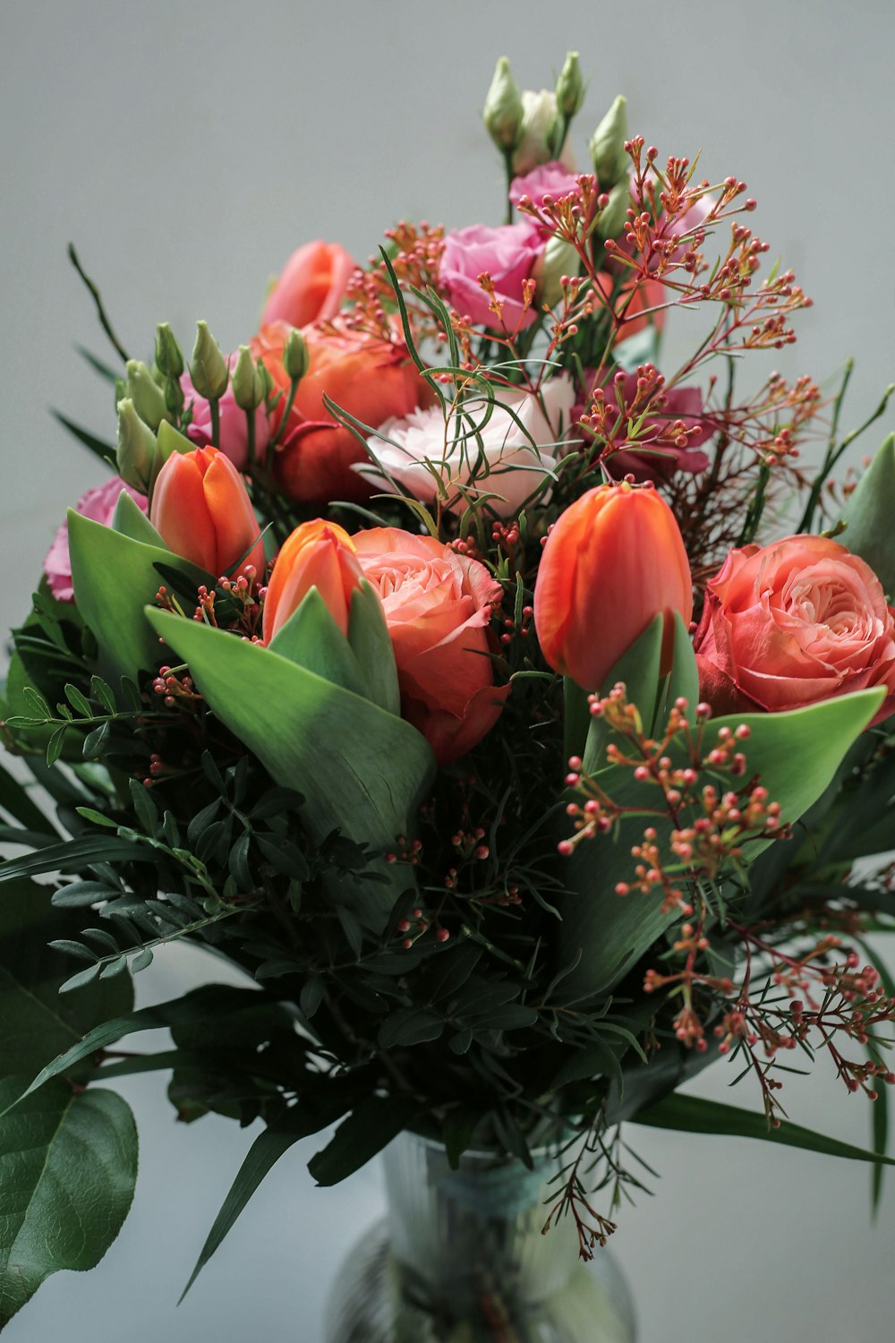 a vase filled with lots of flowers on top of a table