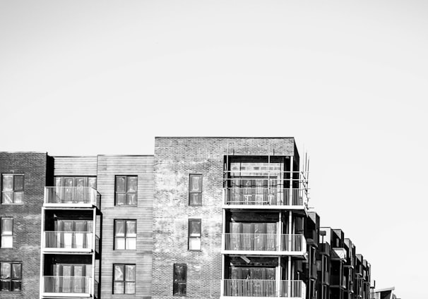 a black and white photo of a row of apartment buildings