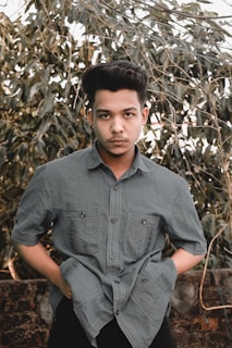 A stylish young person holding a picksoap bar while walking through an urban park.