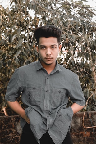 A stylish young person holding a picksoap bar while walking through an urban park.
