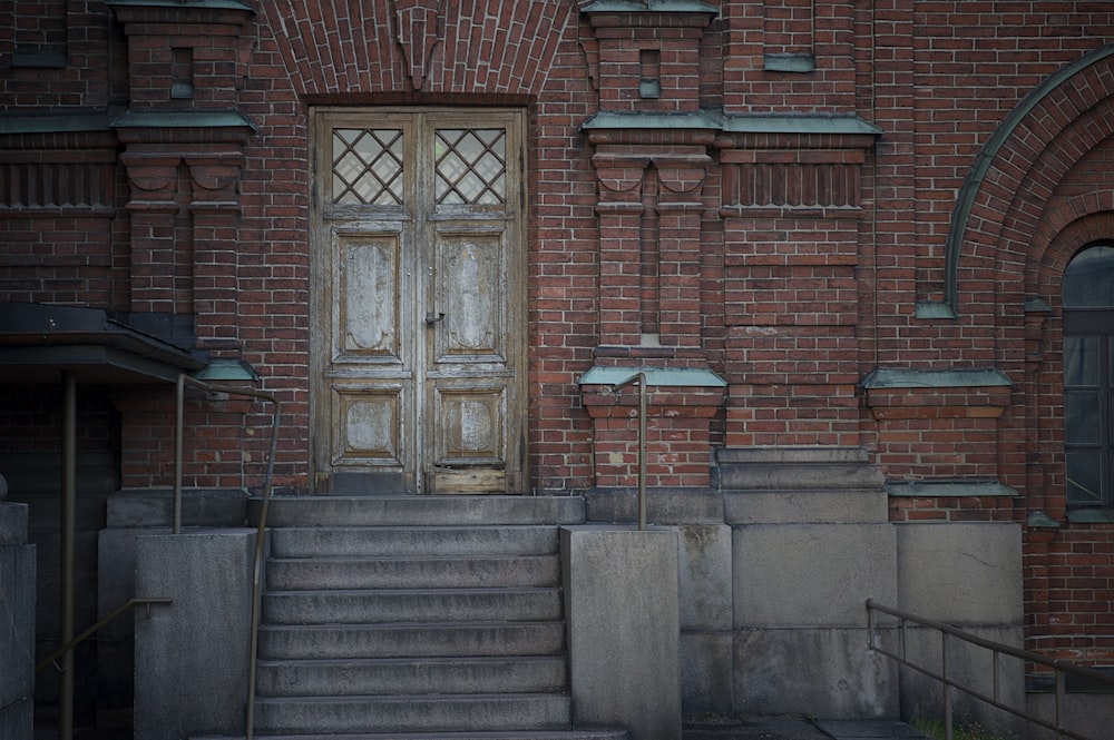 an old building with stairs and a door