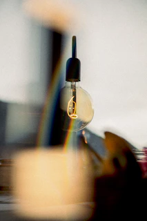 Close-up of a smart light bulb changing colors with an app on a smartphone.