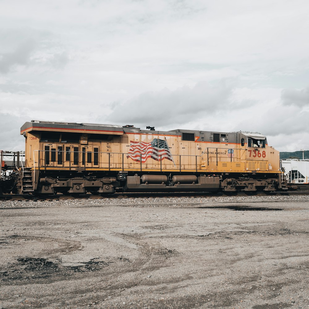 a yellow train with an american flag painted on it