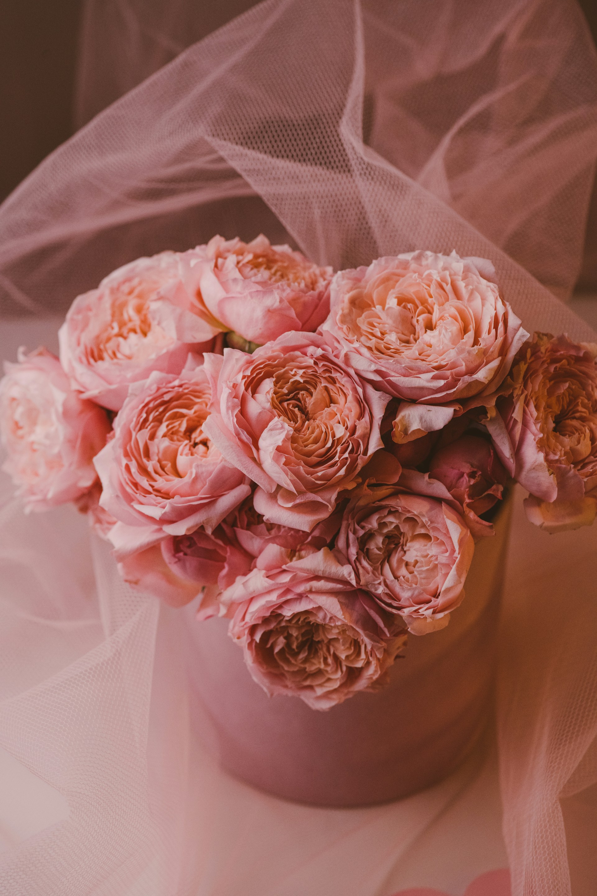 a vase filled with pink flowers on top of a table