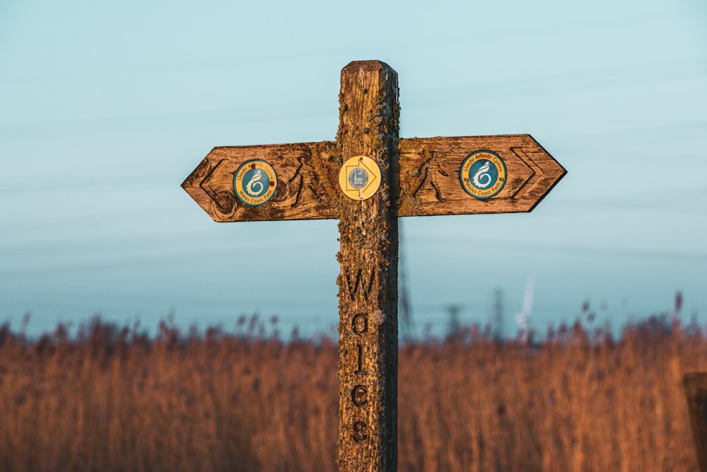 a wooden cross with a blue sky in the background