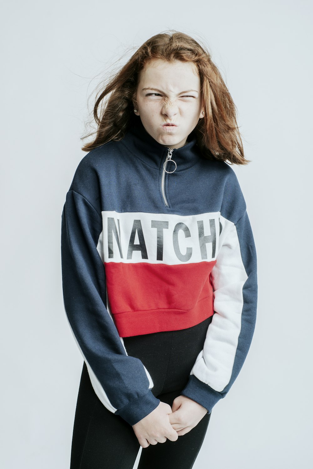 a woman in a blue and red sweatshirt with the word match on it