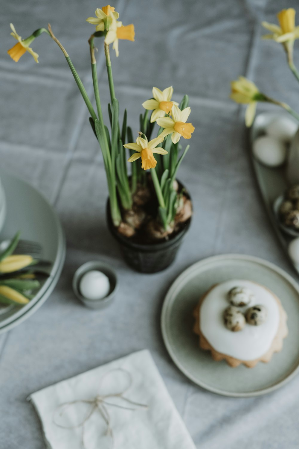 a table topped with plates of food and flowers