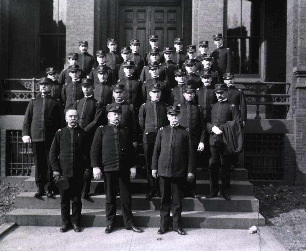 a group of men standing on the steps of a building