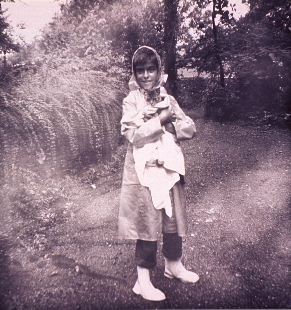 a young girl is holding a baby in her arms