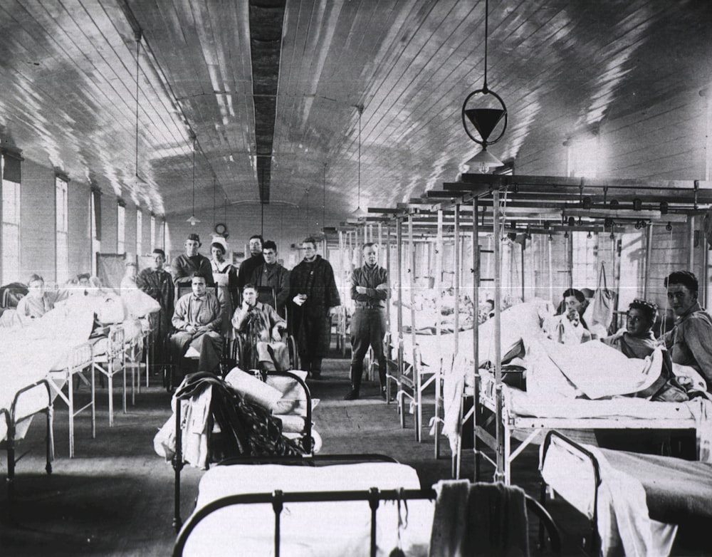 a black and white photo of people in a hospital