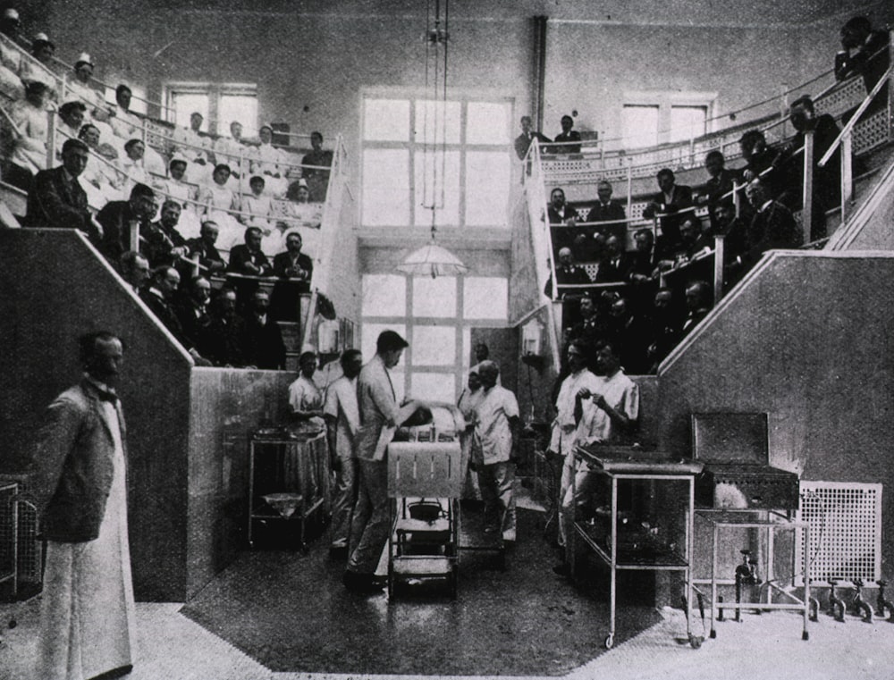 a black and white photo of people in a room