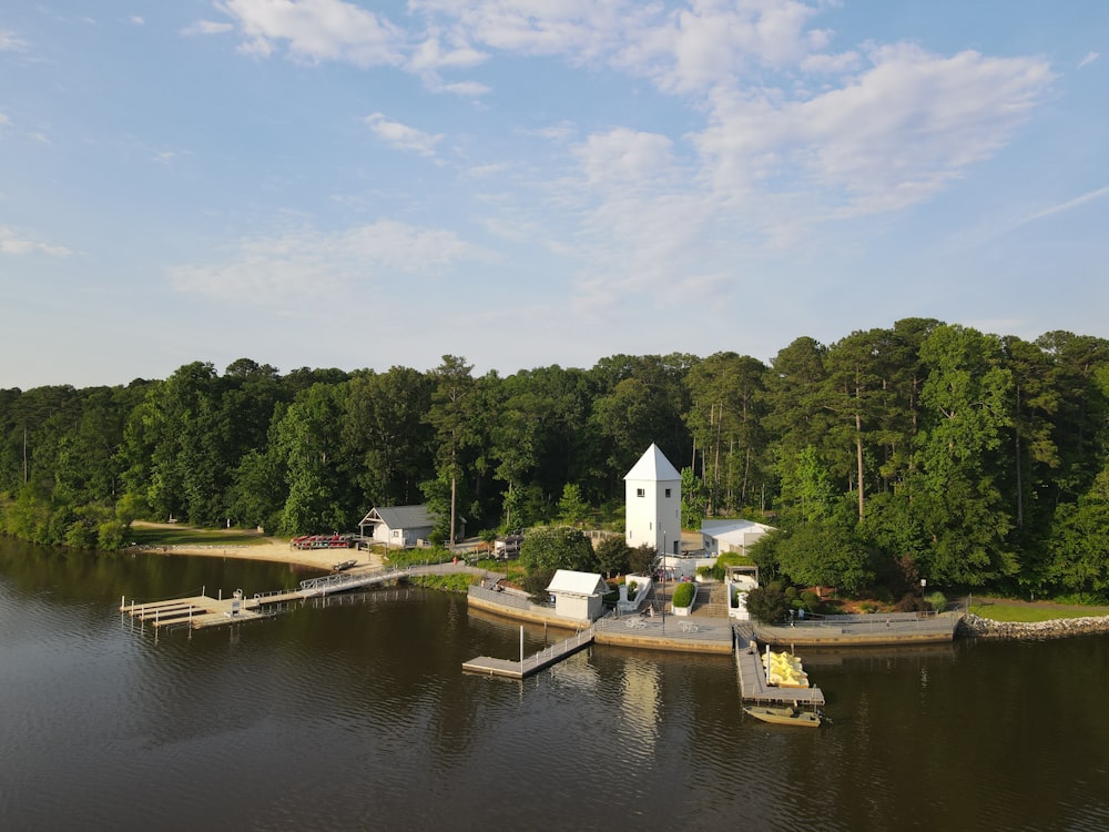 a house on a lake surrounded by trees