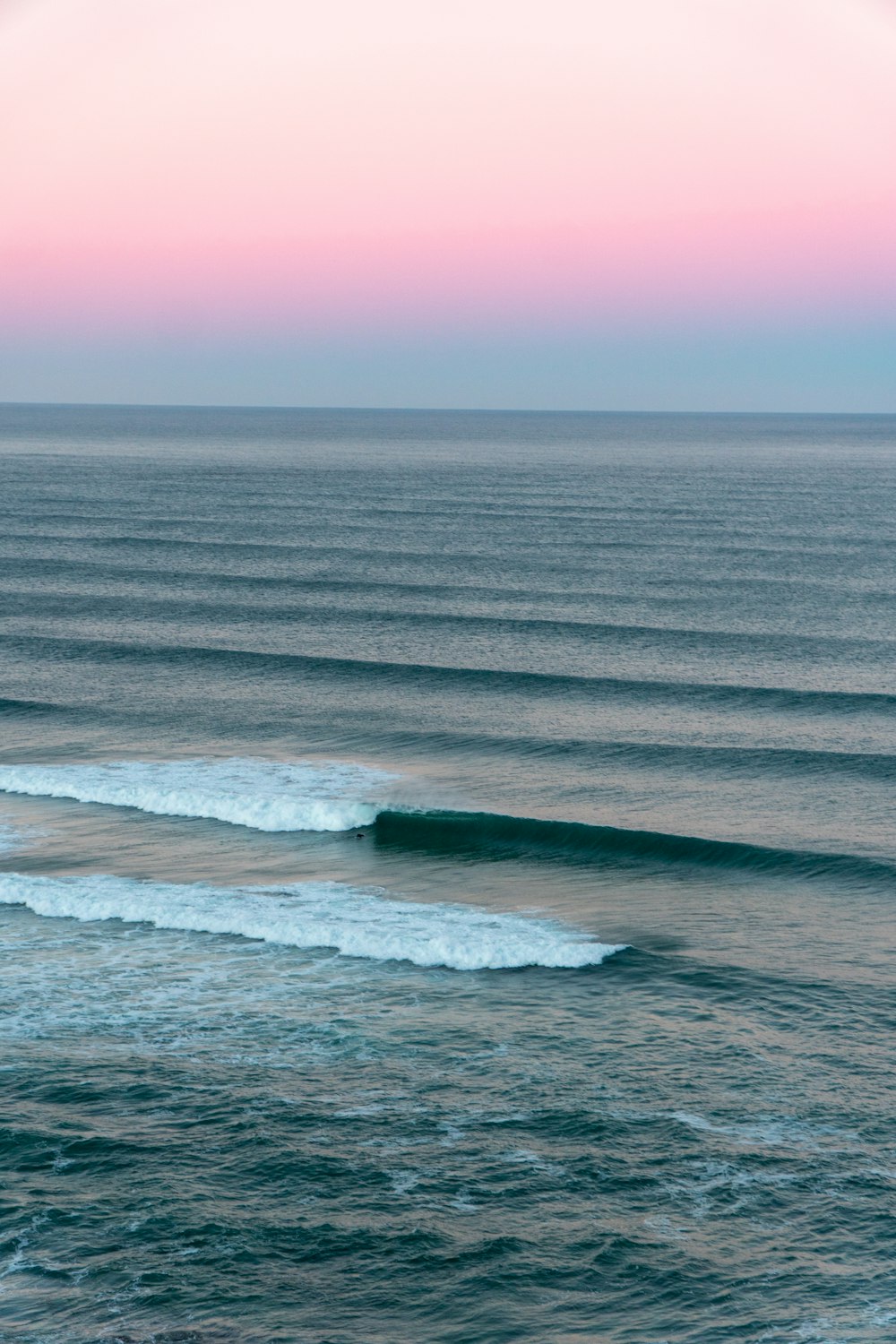 a large body of water with waves coming in to shore