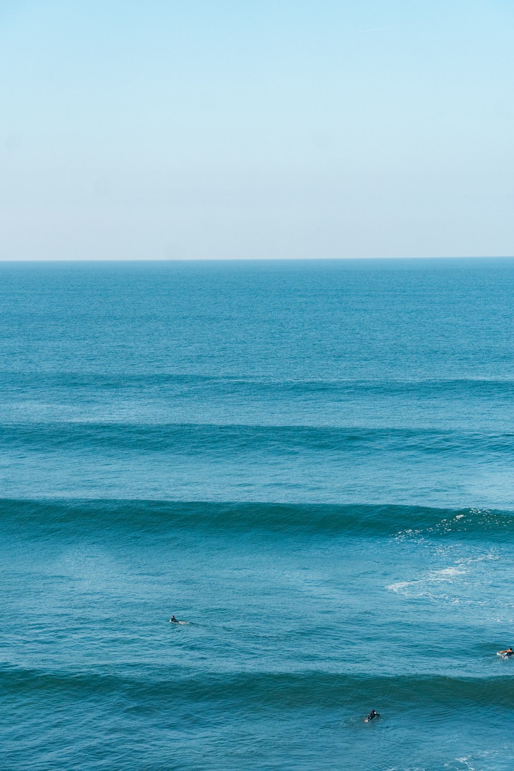 a man riding a wave on top of a surfboard