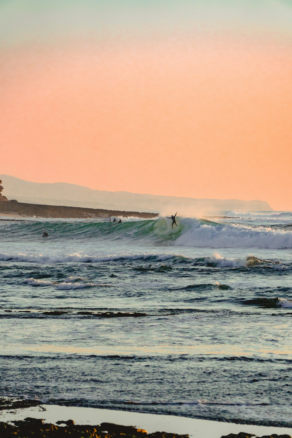 a person riding a surfboard on a wave in the ocean