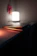 A cozy room softly lit by a glowing lantern beside an open laptop showing the Hopway | siraj homepage.