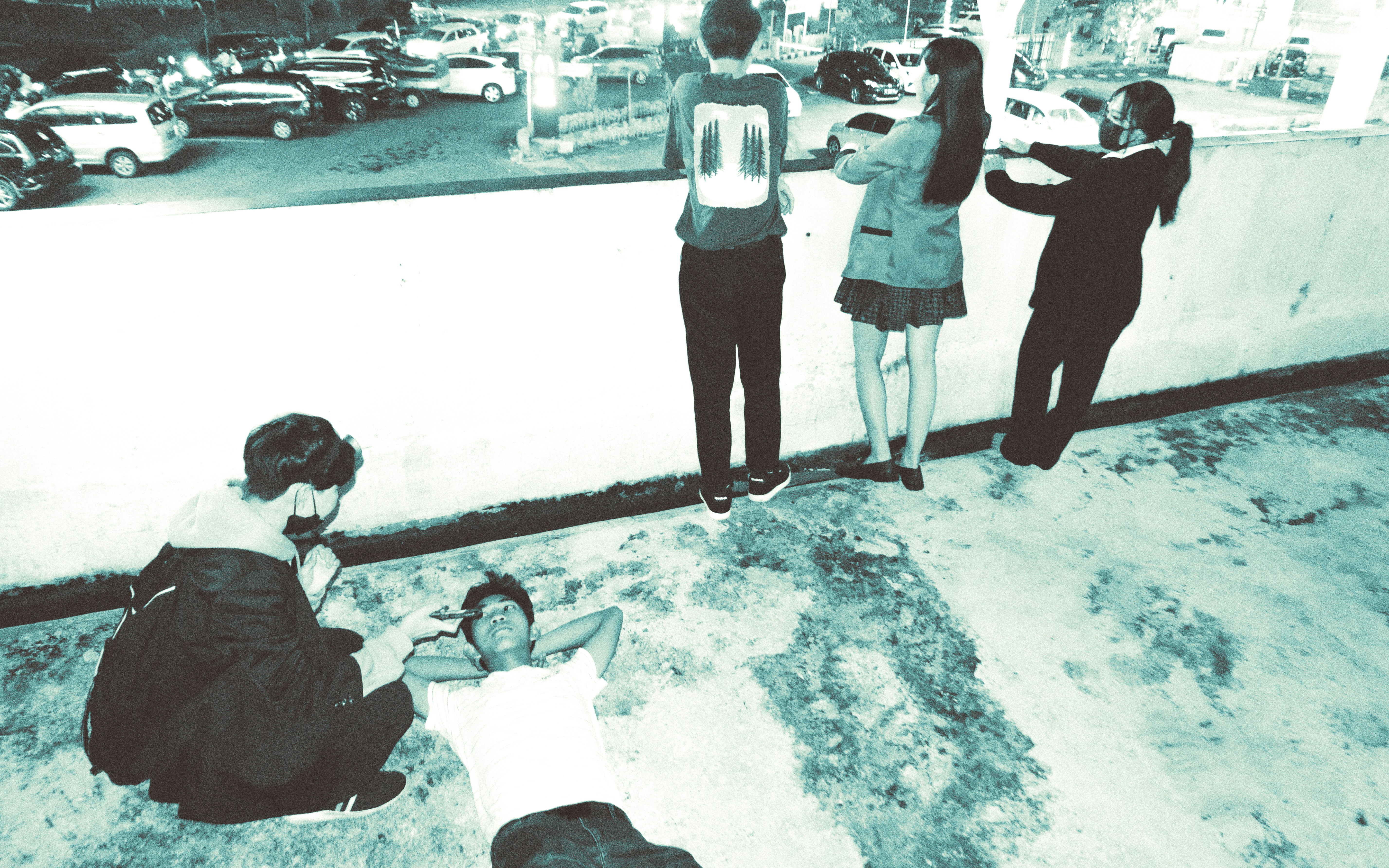 a group of people standing and sitting on the ground